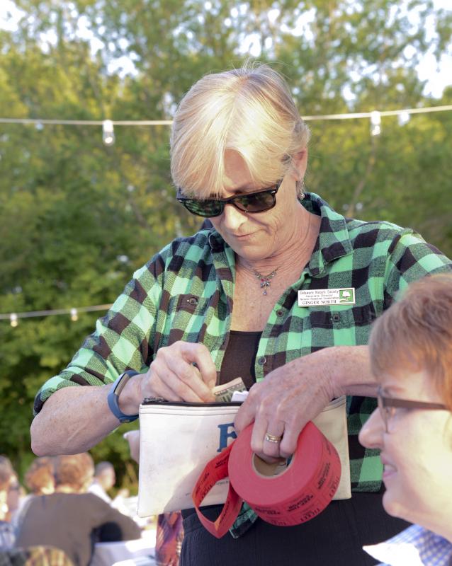Ginger North, Delaware Nature Society Associate Director of Natural Resources Conservation, sells raffle tickets.